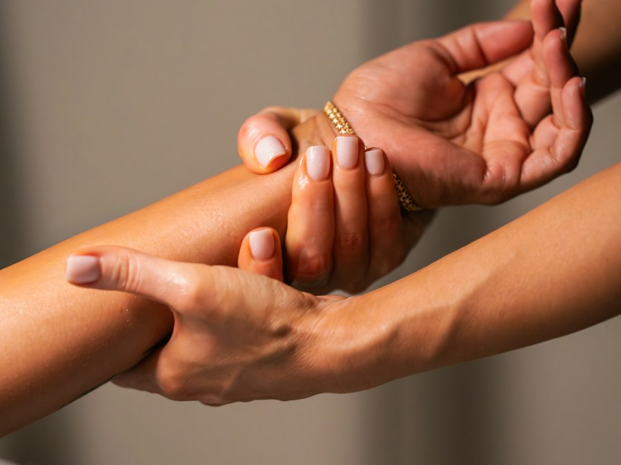 Hands gently massaging a forearm